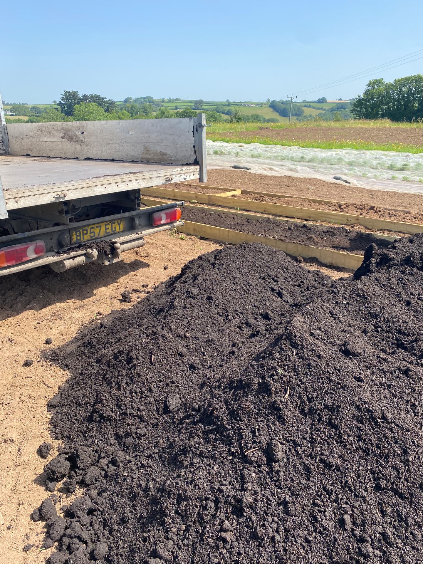 Loose tipped Coastal Compost dropped beside the tipper van at a Devon smallholding